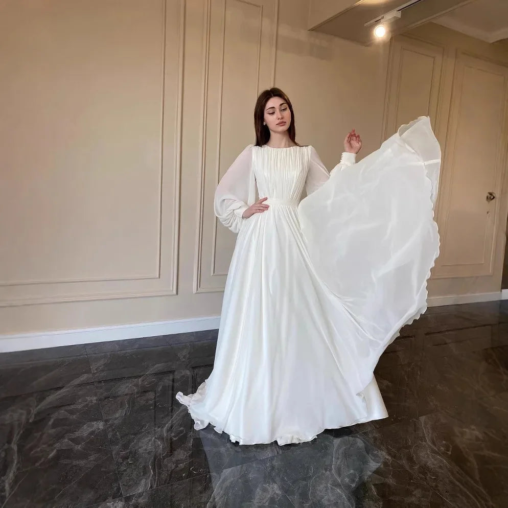 فستان نسائي طويل أنيق بكسرات وأكمام منفوخة – عباية محتشمة بتصميم راقٍ مناسبة لرمضان والمناسبات